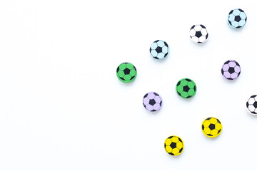 Wooden figures in the form of soccer balls on a white background