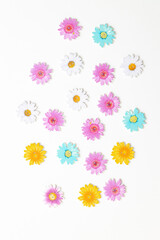 Wooden figures in the form of colored flowers on a white background