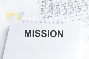 MISSION text on a notebook on the graph background