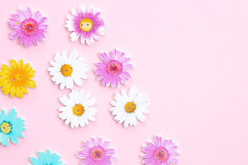 Fototapeta na wymiar Pattern of colored flowers on pink background