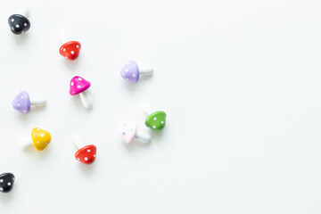 Figures in the form of colored mushrooms on a white background