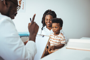 Pediatrician's Office. Shot of a single mother bringing his little boy for a checkup. An adorable...
