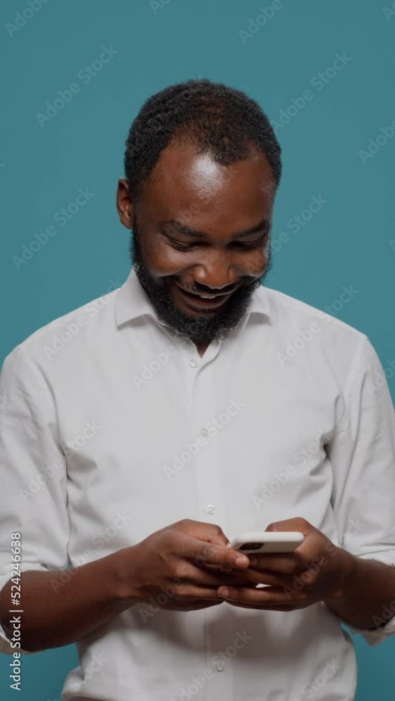 Poster vertical video: millennial worker using social media app to text messages on smartphone, talking on 