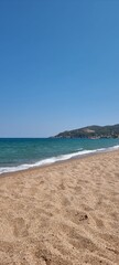 Fototapeta na wymiar Pals Spain July 2022 lonely beach and the sea against blue sky