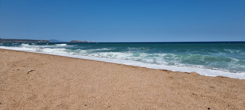 Pals, Costa Brava, Spain July 2022, beach and sea against blue sky with Illes Medes in beautiful weather