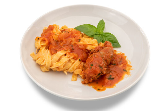 Egg pasta tagliatelle with tomato sauce and beef meat roll in white plate, typical recipe from Puglia, Italy, called braciola al sugo. isolated on white, clipping path