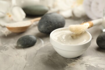 Cosmetic product for spa body wraps on light grey stone background