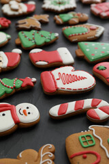 Many different delicious Christmas cookies on black table