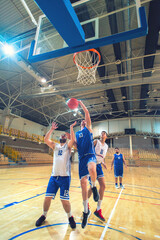 Fototapeta premium Basketball players playing basketball in the sports hall