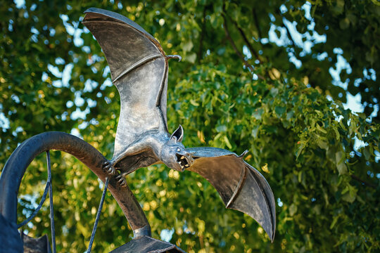 Brest, Belarus. Jun 2022. The bat - metal statue of scary, spooky bat with spread wings. Part of the "Night Watch" sculpture based on scene from Gogol's story "Viy", on the Alley of Literary lanterns