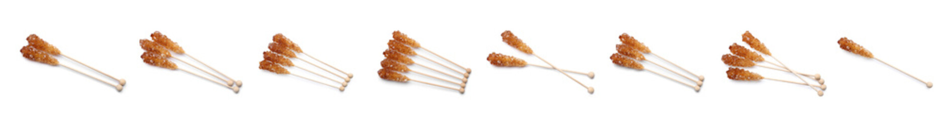 Set of wooden sticks with sugar crystals on white background, banner design. Tasty rock candies