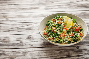 arabic salad tabbouleh on a rustic wooden background