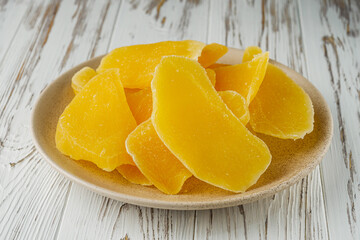 delicious dried mango on a white wooden rustic background
