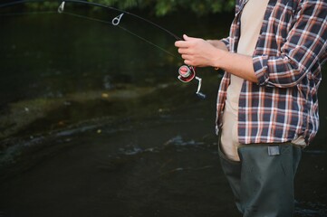 Young man flyfishing at sunrise