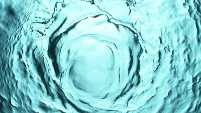 Super slow motion of water surface on light blue background. Filmed on high speed cinema camera, 1000 fps.
