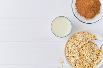 plate of oatmeal and cocoa carob and a glass of milk. healthy food. diet.