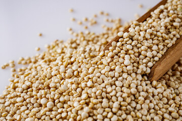 white quinoa seeds on a white acrylic background