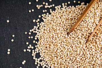 white quinoa seeds on a dark rustic background