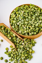 dried green peas on a white acrylic background