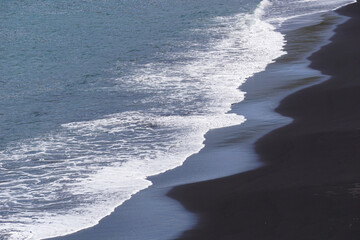 Reynisfjara - black beach in Iceland, close-up on waves