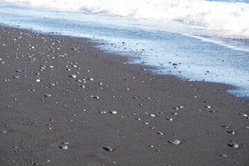 Reynisfjara - black beach in Iceland, close-up on waves
