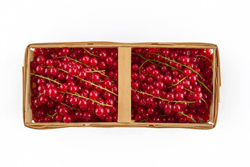 Red currants in wooden container isolated on white background.. Top view.