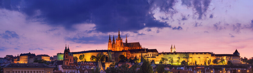 Fototapeta na wymiar Cityscape at sunset, panorama, banner - view of the historical district of Hradcany with the castle complex Prague Castle, Prague, Czech Republic