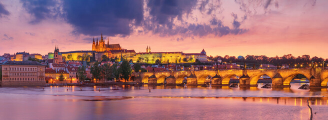City summer landscape at sunset, panorama, banner - view of the Charles Bridge and castle complex...
