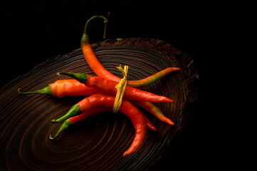 Bunch of fresh hot red chilies tied up with string. Beautiful, rustic food photography of ripen...