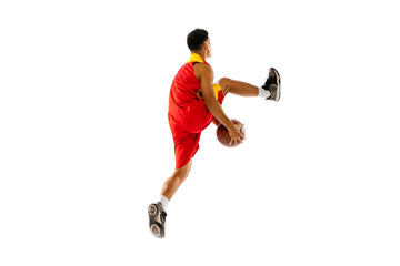 Dynamic portrait of young man, basketball player throwing ball in a jump isolated over white studio...