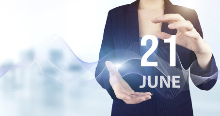 June 21st . Day 21 of month, Calendar date. Hand hold virtual hologram calendar date with digital wave.  Summer month, day of the year concept.