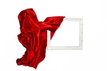 Flying red satin cloth unveiling a white vintage frame.