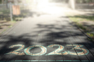 2023 number written with chalk on a park alley