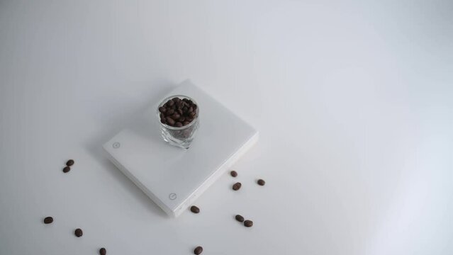 coffee beans on a scale on white background