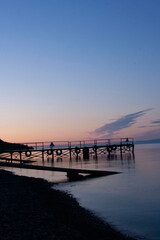 Dawn over the lake landscape. Lake at dawn. Beautiful sunrise over lake pier. Boat at lake pier at dawn