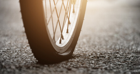 Bike flat tire on pavement, soft and selective focus.