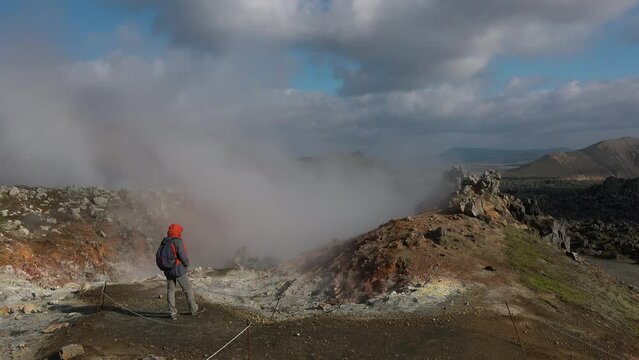 Steam emitting from fumarole in geothermal area of Hverir. Sulphur dioxide erupting from volcanic crater at Namafjall. Geyser in famous tourist attraction in Iceland