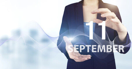 September 11st . Day 11 of month, Calendar date. Hand hold virtual hologram calendar date with...