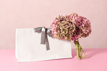 White shopping bag with beautiful bouquet