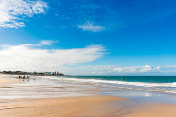 Ocean waves and sandy beach on a sunny day. Nature tropical background. Travel tourism. Kellys Beach, QLD, Australia