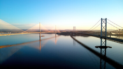 Aerial drone sunrise view of The Queensferry Crossing bridges over the Firth of Forth, Edinburgh, Scotland, UK.