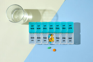 Medicine concept; Take medicine on time every day. closed up picture of pills capsules in pill...