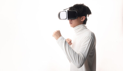 Young man using virtual reality headset looking up and interacting with Facebook Youtube Steam VR content. Isolated on a white background studio portrait. VR, future, gadgets, technology, concept