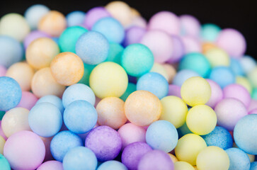 The Foam beads of various colors brightly colored on black color background