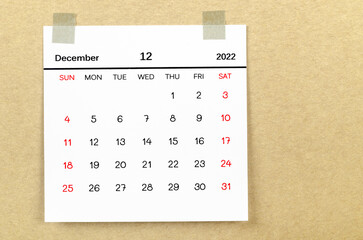 December 2022 calendar on brown background.