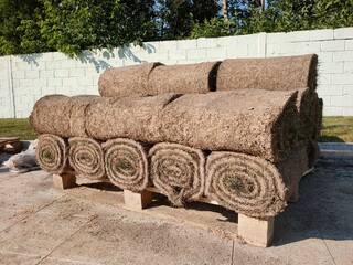 Stack of turf grass rolls for lawn meadow.