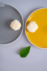 two yellow and gray plates with pashmak cotton candies on them and a green leaf. together visually form a smiley smile. abstract emoticon. Smiling human face from plates and leaves. World smile day