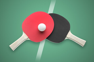 Paddles and ball on green ping pong table, top view