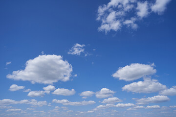 Bright blue sky with clouds to the horizon