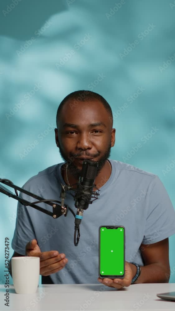 Aufkleber vertical video: influencer holding smartphone with green screen on display while filming video for p